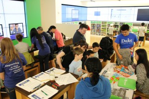Busy room full of problem solvers and their families. 